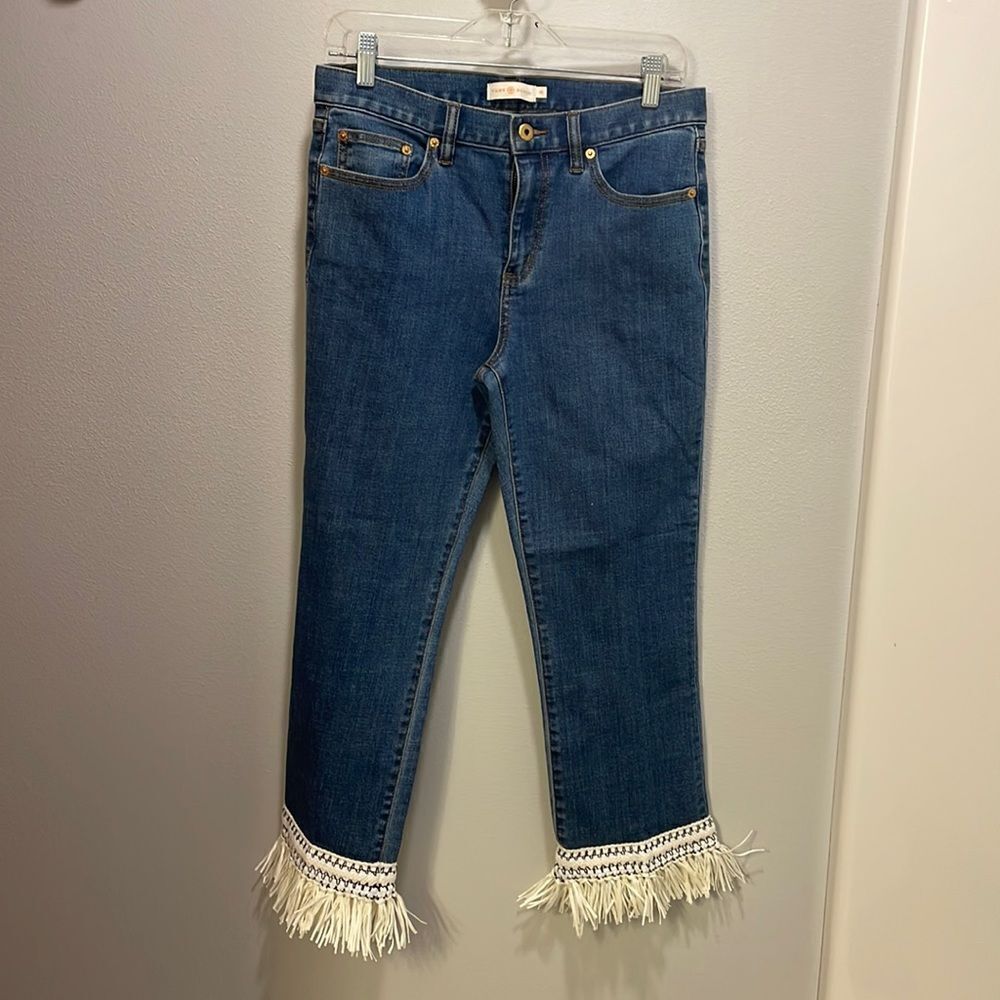 Tory Burch Connor jeans in medium allover stone wash. Cropped. Raffia fringed